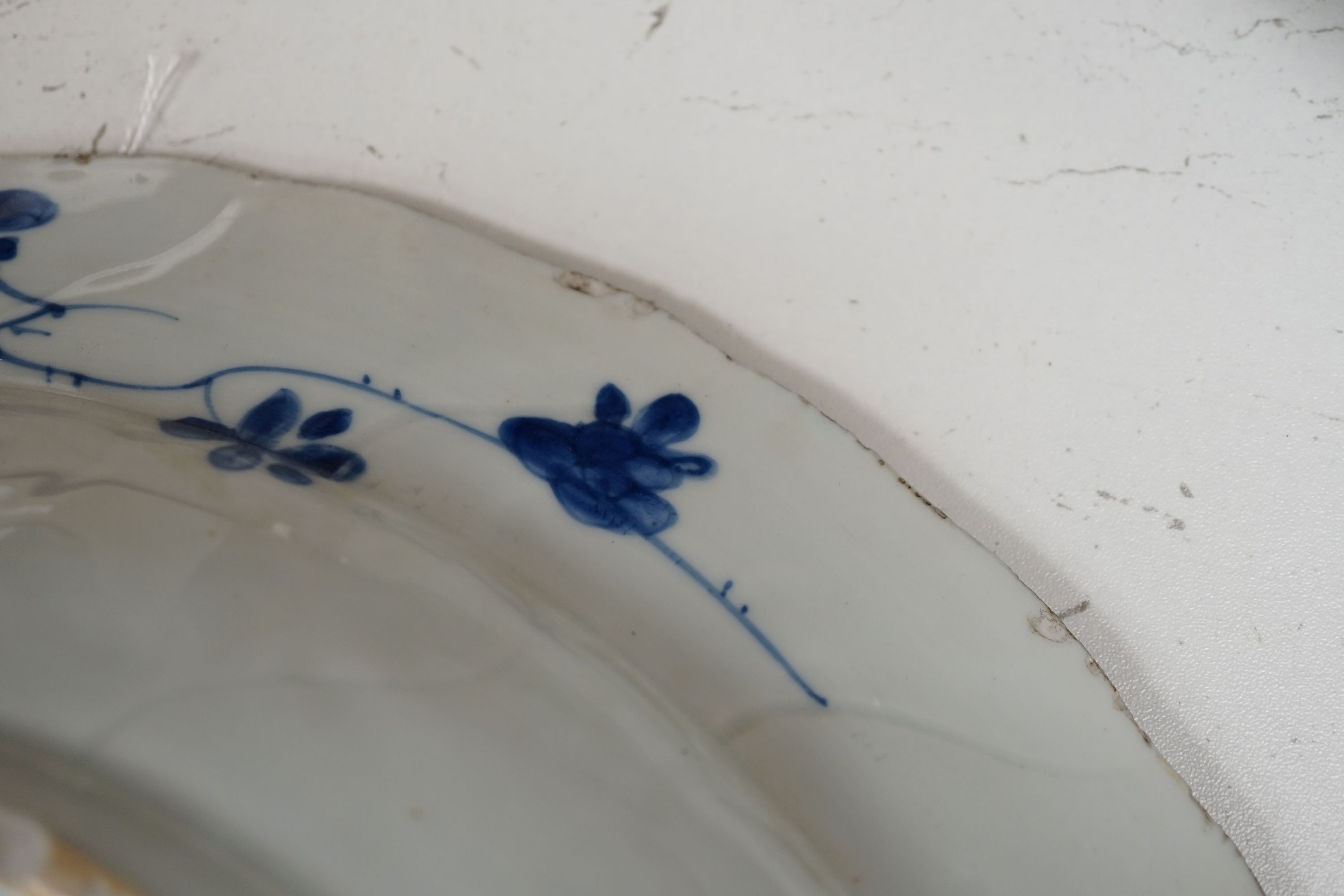 A pair of Chinese Kangxi blue and white dishes, painted with rock work and flowers, artemisia leaf marks, 37cm diameter